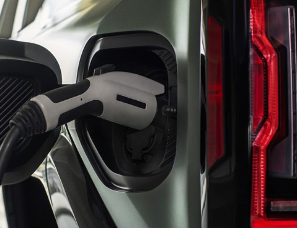 Close up of charging port with charger plugged in on a GMC Hummer EV SUV - Hug GMC in CHARLESTON AR